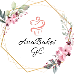 Ana Bakes GC logo — a gold geometric wreath with watercolor pink florals framing a coral cupcake icon