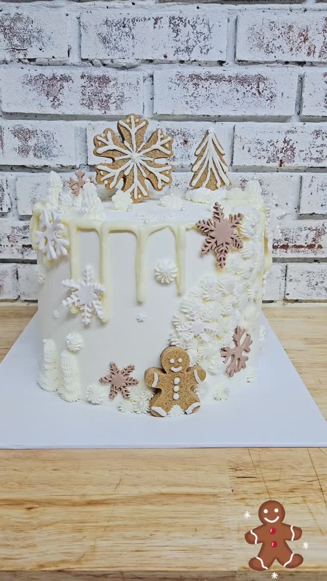 Holiday cake with gingerbread cookie and snowflake decorations