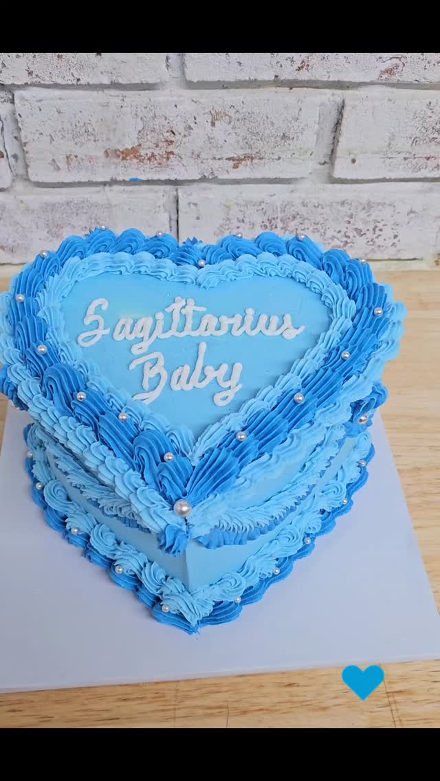 Blue heart-shaped cake with &lsquo;Sagittarius Baby&rsquo; script